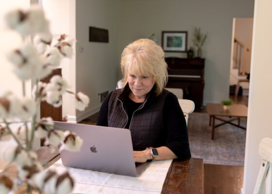 Woman working at a laptop in a home