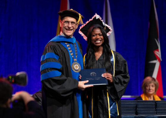 Student receiving degree from President Friedrich