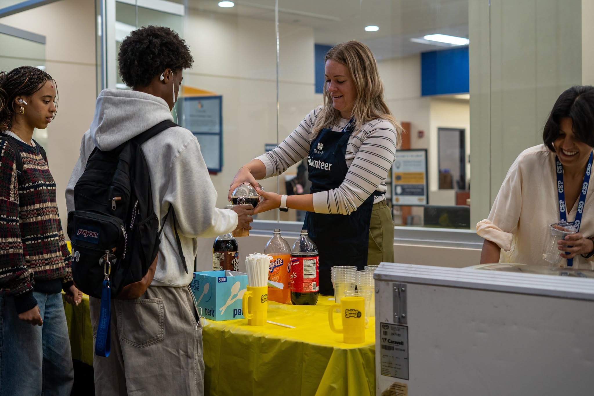 Staff member pouring rootbeer for a student