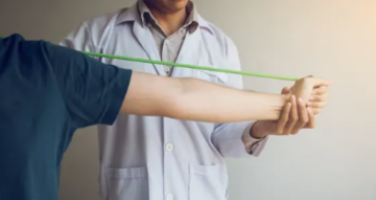 Kinesiology student using a band with a patient