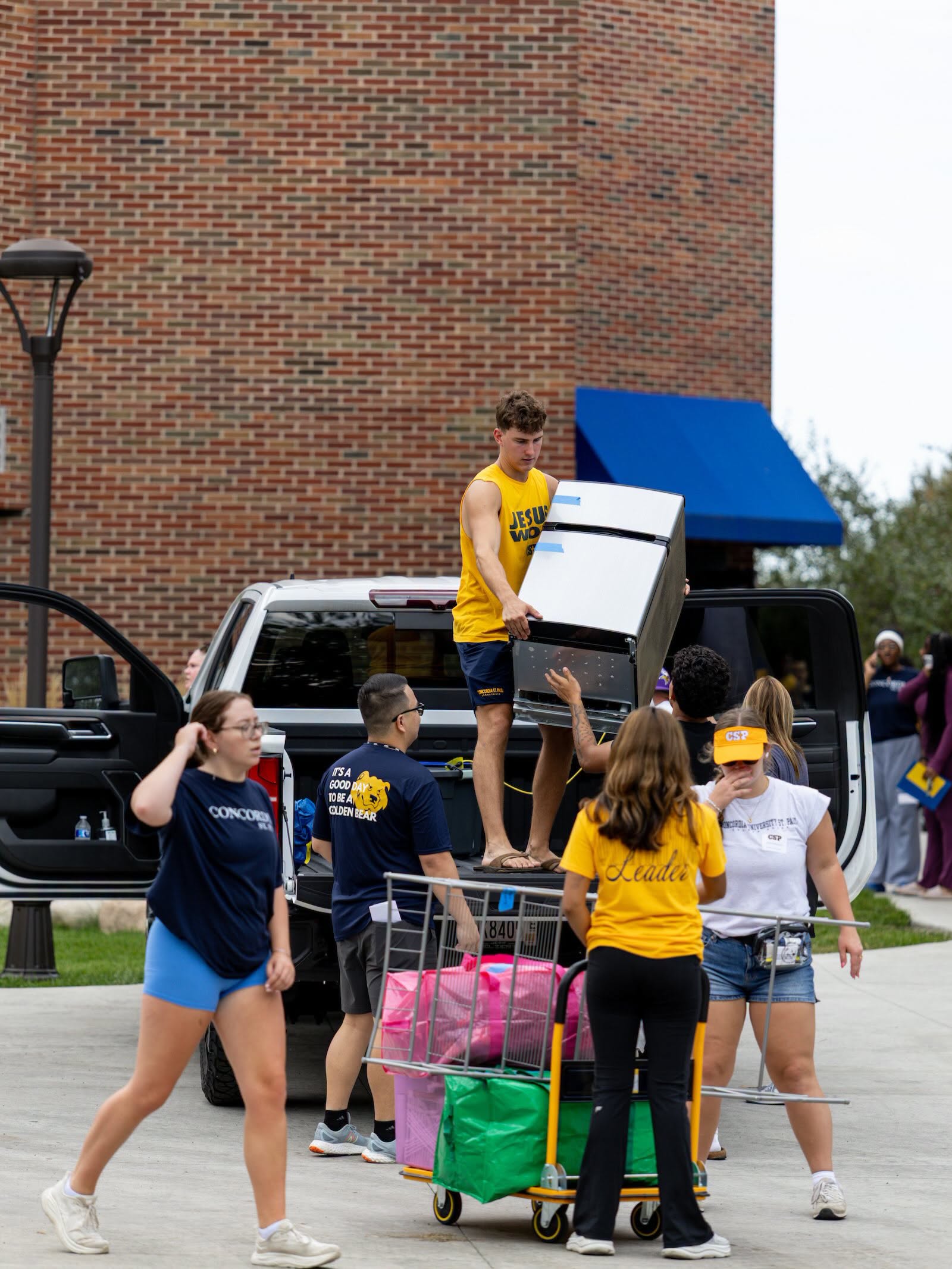 students moving a fridge