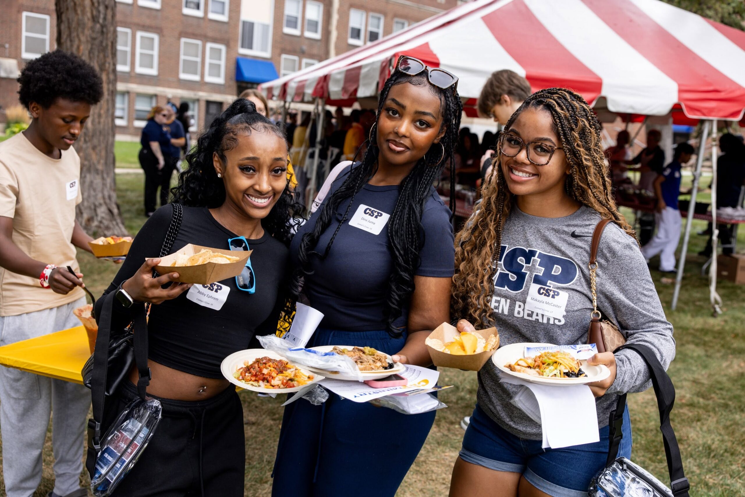 Students at Comet's Cookout with plates of food