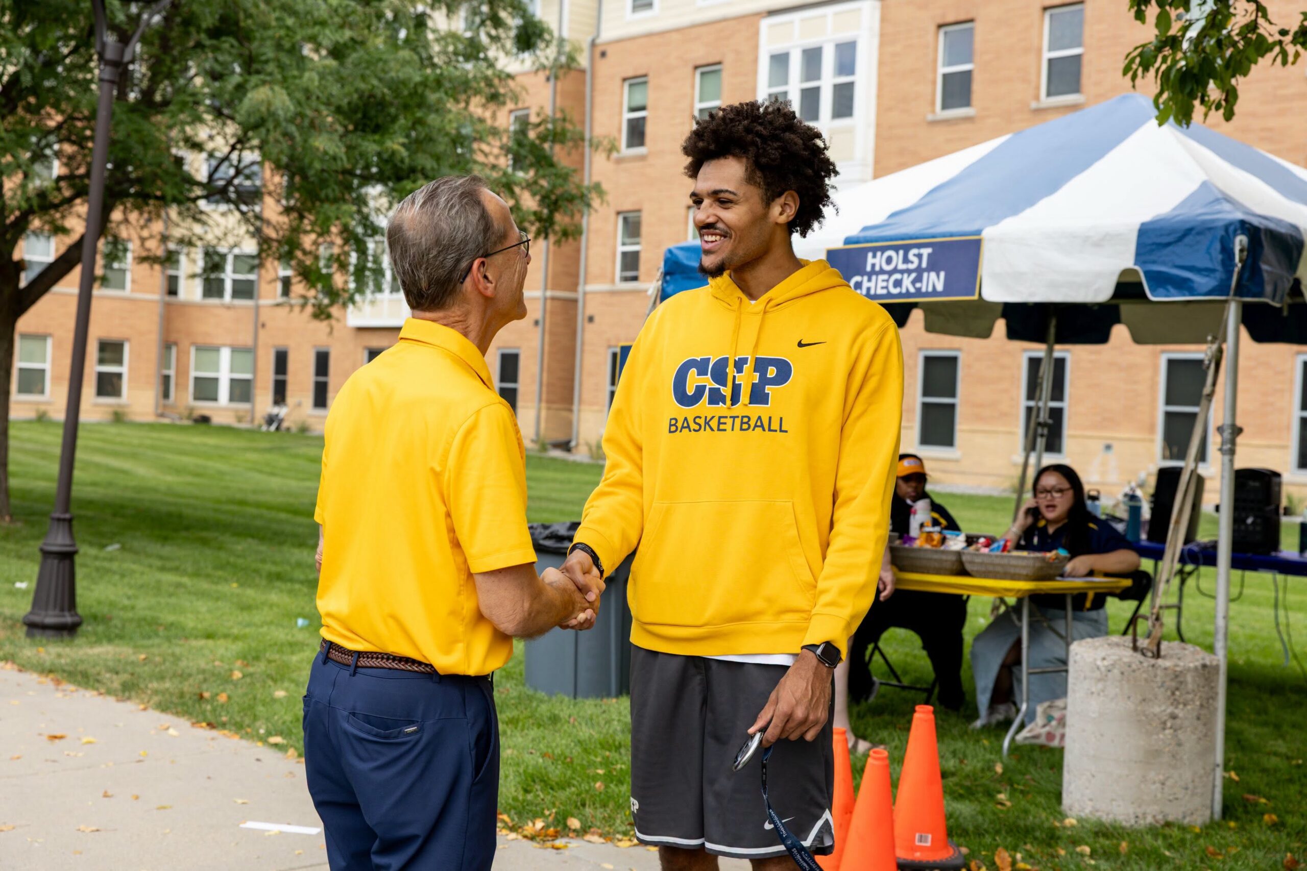 Student shaking President Freidrich's hand